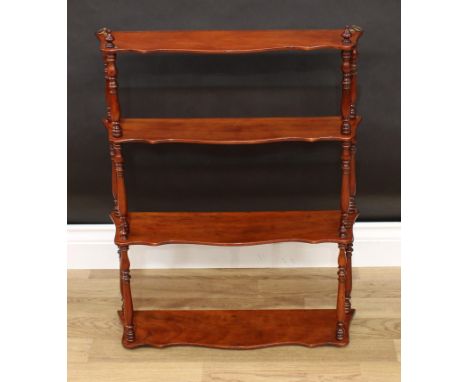 A Victorian walnut four-tier wall shelf, serpentine plateaux, turned finials and supports, 71cm high, 55cm wide, 14cm deep 