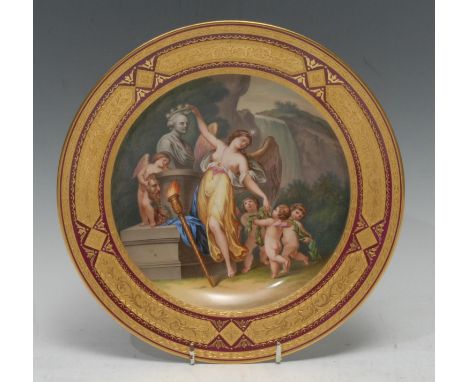 A Vienna circular plate, decorated with a scantilly draped nymph placing a crown on a bust, with cherubs with laurel garland,