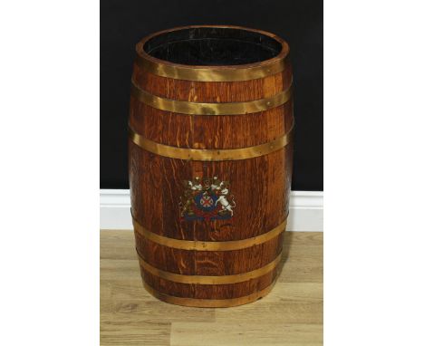 A brass bound coopered oak walking stick stand, printed in polychrome, with a coat of arms, 62cm high, 34cm wide 