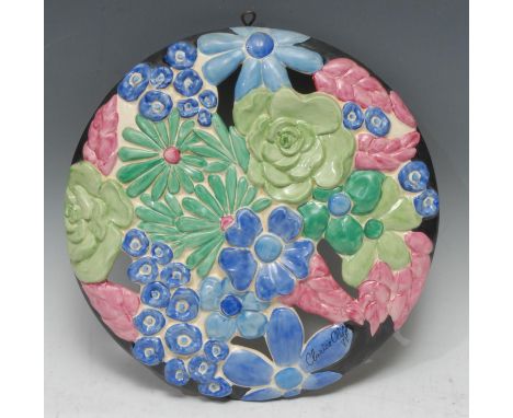 A Clarice Cliff Bouquet pattern wall plaque, relief moulded and pierced with stylised flowers and foliage, in blue, green and