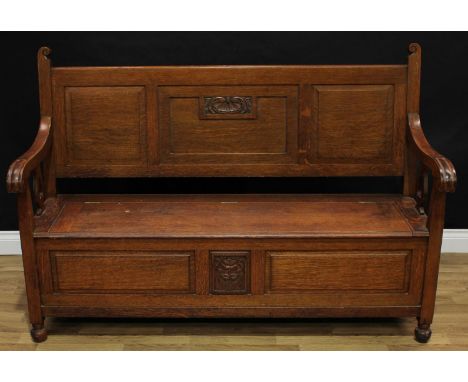 An early 20th century oak hall bench, rectangular back with three raised and fielded panels, scroll arms with shaped splats, 