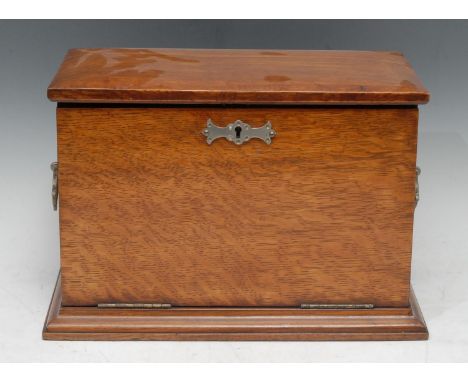 A late 19th century oak stationery box, the interior with inkwell, waterfall letter rack, writing surface, handles to side, s
