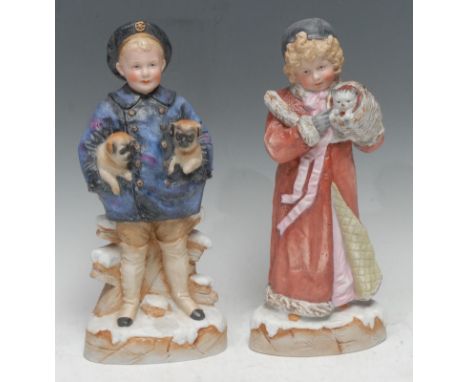 A rare pair Gebruder Heubach bisque figures,  from the Pet Series, Boy with Pugs and Girl with a Kitten, he stands in a silor