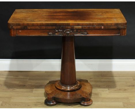 A George IV rosewood card table, rounded rectangular top enclosing an inset baize lined playing surface, columnar base, bun f