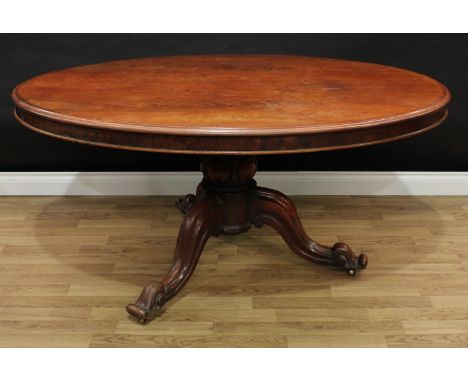 A Victorian mahogany breakfast table, moulded tilting top above a deep frieze, turned and carved baluster pillar, cabriole le