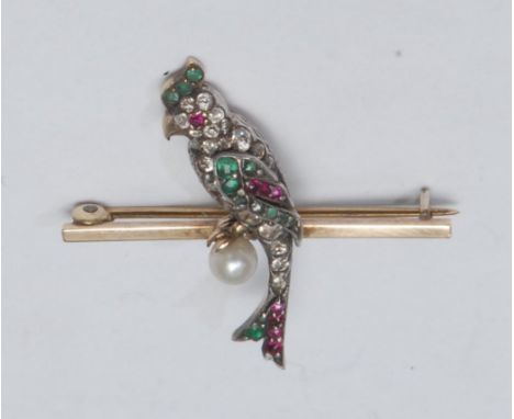 A diamond emerald, ruby and seed pearl parrot brooch, pave encrusted with nineteen mixed cut diamonds, eleven emeralds, eight