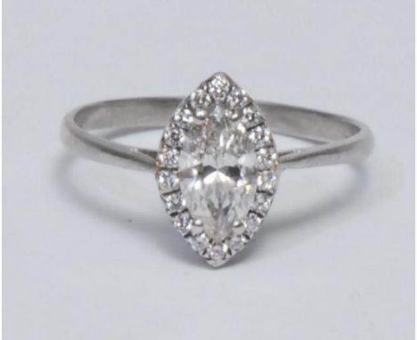 A navette diamond cluster ring, central navette cur diamond surrounded by a band of eighteen round brilliant cut stones, tota
