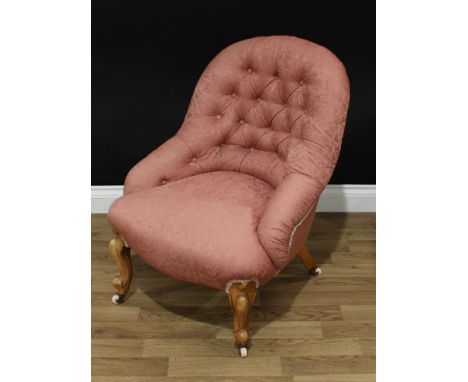 A Victorian walnut button-back nursing chair, stuffed over upholstery, cabriole legs, ceramic casters, 80cm high, c.1860 