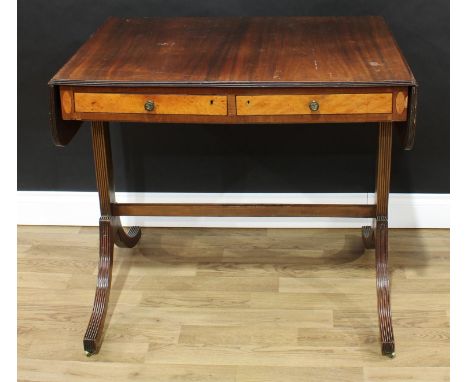 A 19th century mahogany sofa table, rounded rectangular top above a pair of frieze drawers, sabre legs, reeded borders, brass