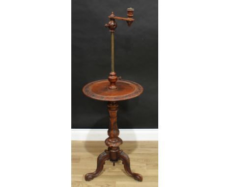 A Victorian walnut combination table and adjustable lamp, the sconce set on telescopic pillar, circular plateau, baluster tri