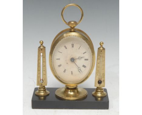 A late 19th century gilt brass desk top timepiece, the 6cm oval clock dial inscribed with Roman numerals, flanked by a pair o