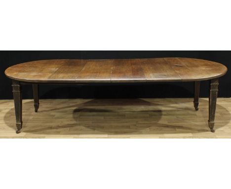 A late Victorian oak wind-out dining table, four additional leaves, fluted tapered square legs, ceramic casters, 74cm high, 1