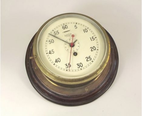 BULKHEAD CLOCK.
A Smith 'Astral' brass bulkhead clock, with outer minutes chapter ring & subsidiary hours dial in Arabic nume