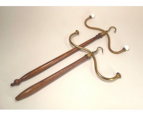 WIG & CLOAK HANGERS.
Two brass mounted wig/cloak hangers.