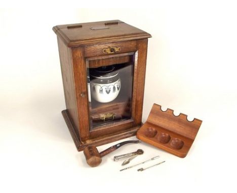 SMOKER'S CABINET ETC.
An oak smoker's cabinet with ceramic jar, 20x17x28cm & a pipe rack etc.