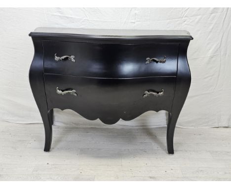 A contemporary ebonised bombe form commode chest. H.88 W.120 D.55cm. 