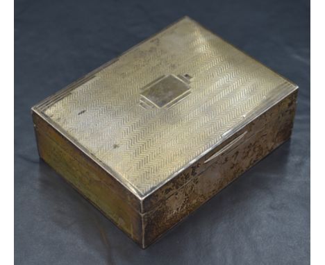 A George V silver cigarette box, of hinged rectangular form engine-turned decoration to the cover centred by a stylised vacan