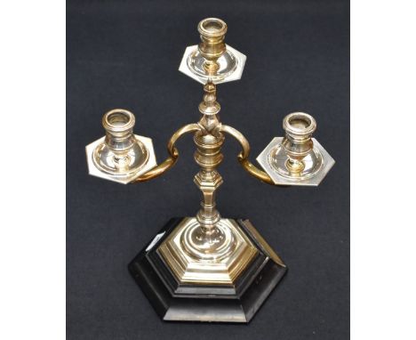 An impressive early Queen Elizabeth II silver three-branch candlestick, of turned and hexagonal form, the central columns fin