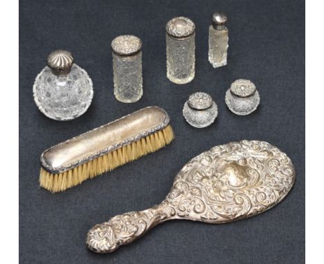 A selection late 19th and early 20th century silver mounted dressing table wares, including four cut glass containers all hav