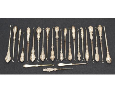 A collection of twenty-five silver handled button hooks, of various size and designs including embossed designs, engine-turne