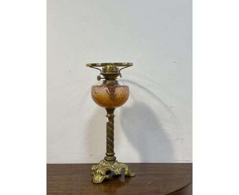 A late Victorian floral and spiral cast brass oil lamp with moulded cranberry glass reservoir, H44cm