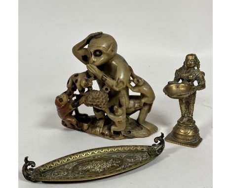 An Indian cast brass standing figure of a goddess with lotus shaped incense holder dish, raised on circular and square moulde