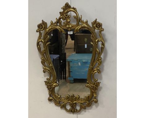 A Rococo style gilt framed wall hanging mirror, the frame of cartouche form decorated with scrolling acanthus, 91cm x 57cm