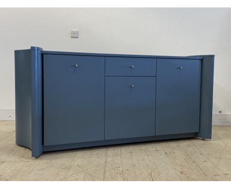 A Contemporary blue painted hardwood sideboard of curvilinear outline, fitted with a centre drawer and cupboard, flanked by t