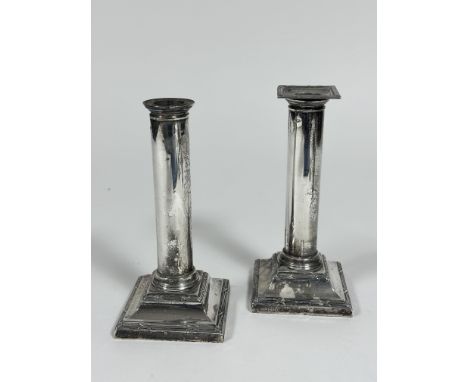 A pair of Edwardian Sheffield silver cast candlesticks of column form on stepped bases with reeded and cross bordered design,