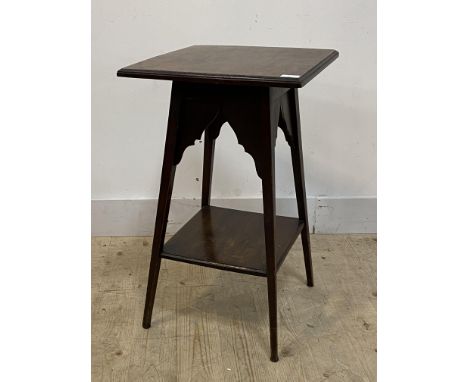 An Edwardian stained mahogany lamp table, the moulded top raised on splayed square tapered supports united by an under tier, 