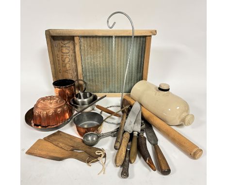 A stoneware hot water bottle, a Glassick glass ribbed treen wash board, a group of copper skillets, mousse mould, various kni