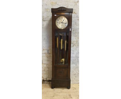 A 1930's oak cased Westminster chiming longcase clock, the silvered dial with Arabic chapter ring, H202cm, W50cm, D26cm