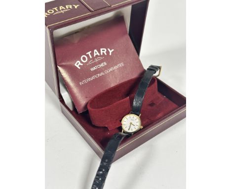 A Rotary 9ct gold lady's wrist watch with white enamelled dial and baton hour markers, on black leather strap, with tang buck
