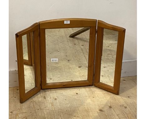 A polished pine triptych mirror 83cm x 55cm