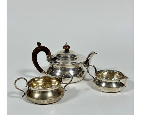 A Birmingham silver three piece morning tea service, the teapot of squat form, the treen knop and C scroll handle to side, (h