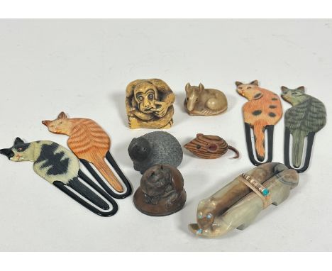 A pair of Inuit carvings of two foxes with inset turquoise eyes, (2cm x 9cm) joined with straw and beads to top, a netsuke st