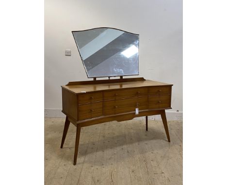 Alfred Cox for AC furntiture, a mid century teak dressing table, the shaped mirror over angular concave front base with four 