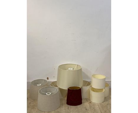 A collection of ten lamp shades of various designs and sizes