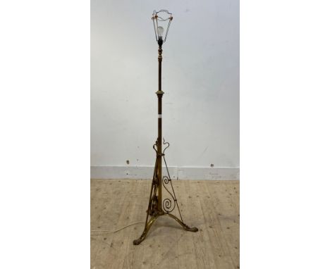 An early 20th century brass standard lamp on triple splay paw supports, H138cm (excluding bulb)