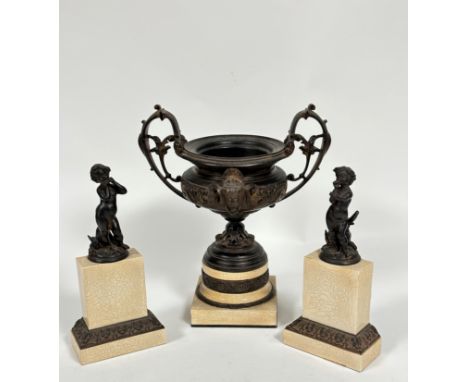 A resin model of a classical two handled urn with C scroll handles to side and mask panel front, raised on resin craquelure f