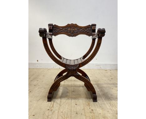 An Italian Dagobert style 'X' frame chair, the arms with stylised mask terminals, raised on sledge supports, H86cm, W63cm, D5