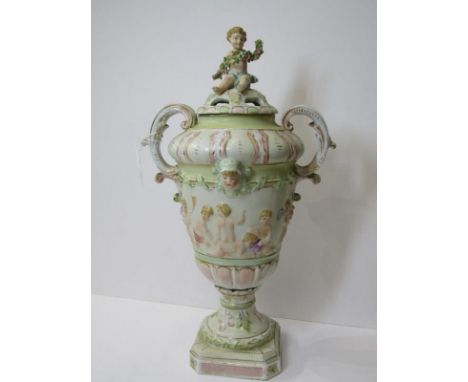 CONTINENTAL PORCELAIN, twin handled square base urn lidded vase, decorated with relief putti, underglaze "R" mark, 13" height