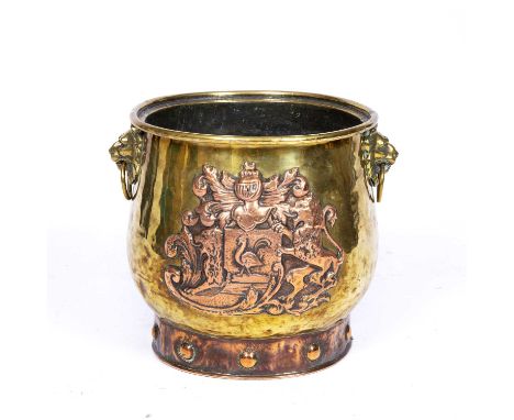An early Victorian brass and copper log bin with lion's mask ring handles and embossed copper coat of arms43cm diameter x 34.