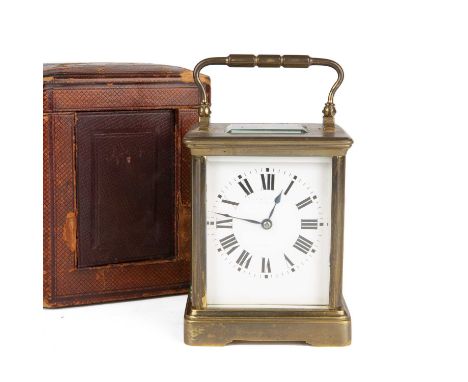 A French brass carriage clock with an enamelled dial and roman numerals 9cm wide 12.5cm high with a fitted leather case.untes