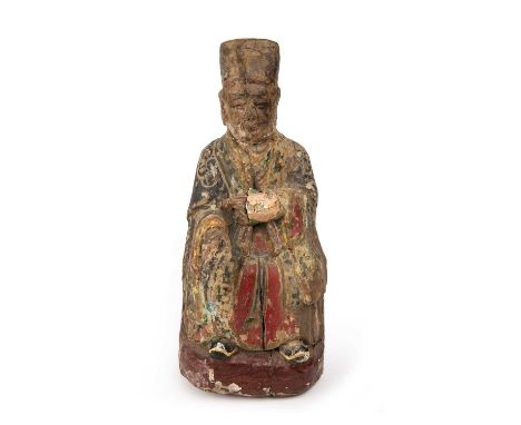 An 18th/19th century carved and painted eastern figure 13cm wide 32cm high together with a manuscript.Rot to base paint loss 