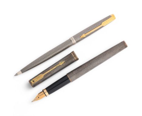 A Parker Cisele fountain pen and ballpoint pen, both with Sterling silver crosshatch bodies and gilt detail, fountain pen has