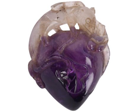 A Chinese carved amethyst pendant in the form of an animal and fruit, height 4cmGood overall condition, several rough edges o