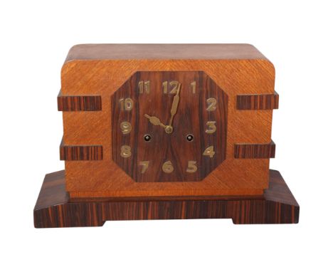 An Art Deco oak and coromandel 8-day mantel clock, with brass numerals, height 25cmRepair to veneer on right back foot, with 