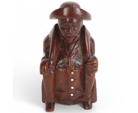 A 19th century coquilla nut snuff box in the form of a seated man with steel buttons, height 8cmGood condition