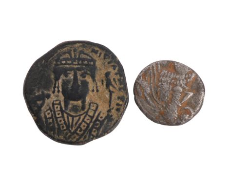An ancient silver Persian coin, diameter approx 16mm together with a bronze Byzantine coin probably 6th century AD, diameter 